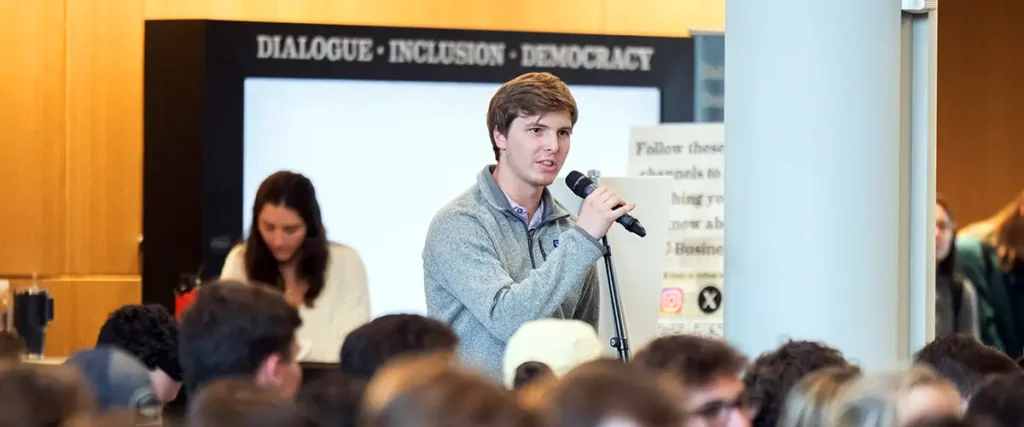 student asks a question of the panelists