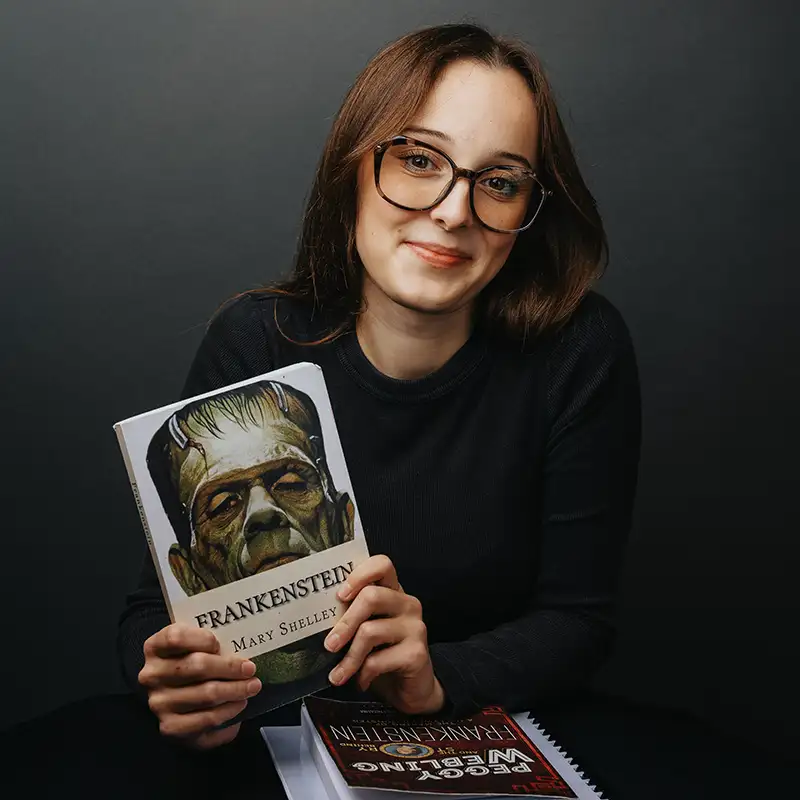 Christina Schwab holding a copy of Mary Shelley's Frankenstein