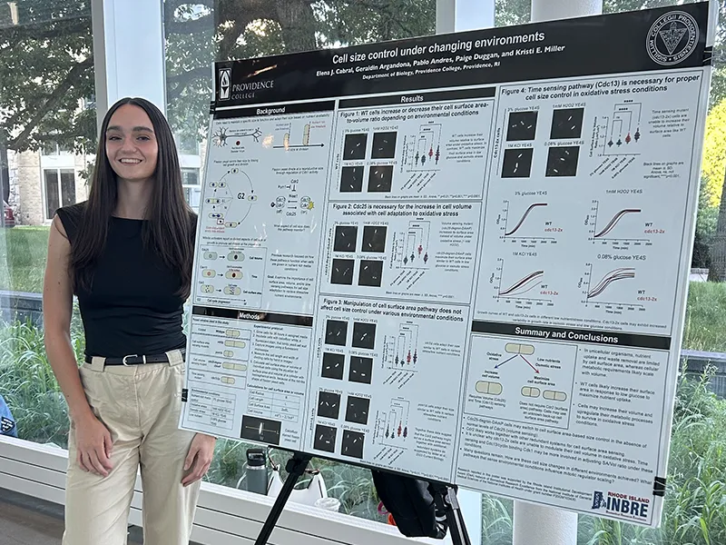 Cabral presents her research with her findings displayed on a large poster board