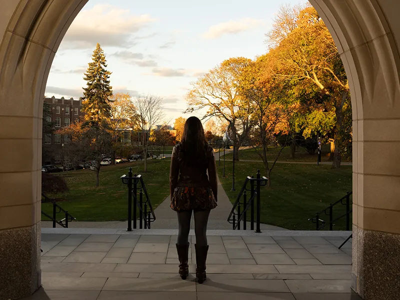 Maisie Meehan Cocker looks out at campus from the steps of the Ruane Center