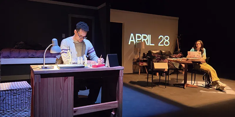 Thomas at his desk in his bedroom; Katherine at the table in the adjacent common room
